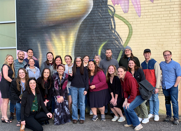 group photo in front of outdoor mural