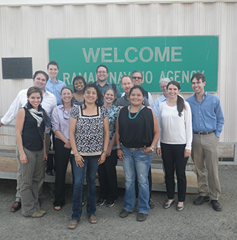 Students standing in front of agency sign