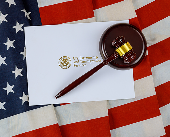 American flag with immigration services sign and gavel