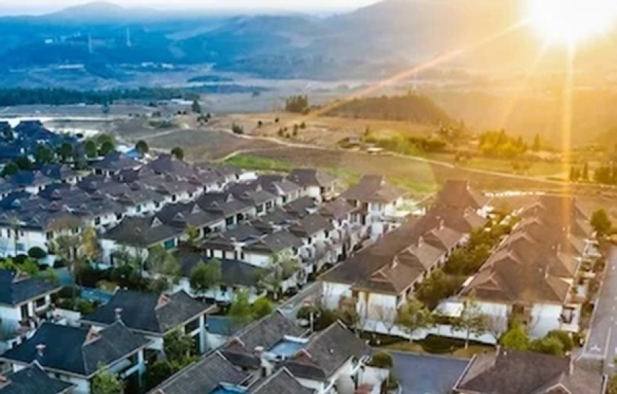 cluster of new housing under sunrise