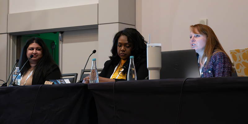 Three panelists seated at table
