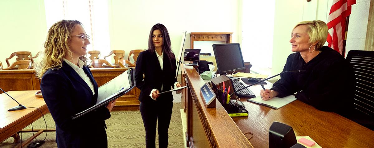 female students in courtroom with female